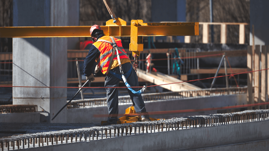 Worker on a jobsite anchored to a horizontal lifeline.