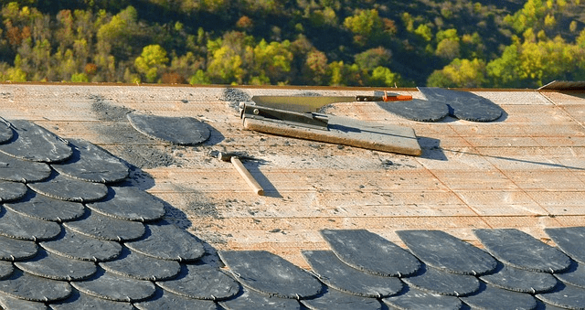 Tile roof being installed by hand.