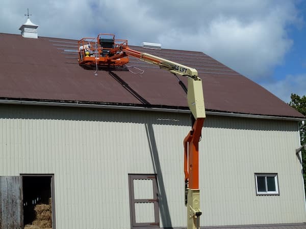 Boom lift accessing a metal roof. 
