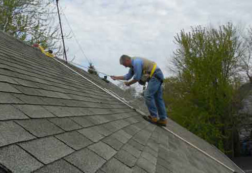 RidgePro hook being used for fall protection on a shingle roof.
