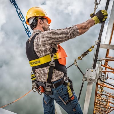 Worker using a fall protection harness and lanyard.